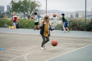 Image of the student playing basketball during Park Pod session