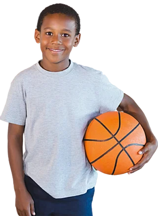 A boy holding a basketball under his right arm