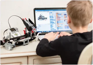 a-boy-on-a-computer-coding-a-robot